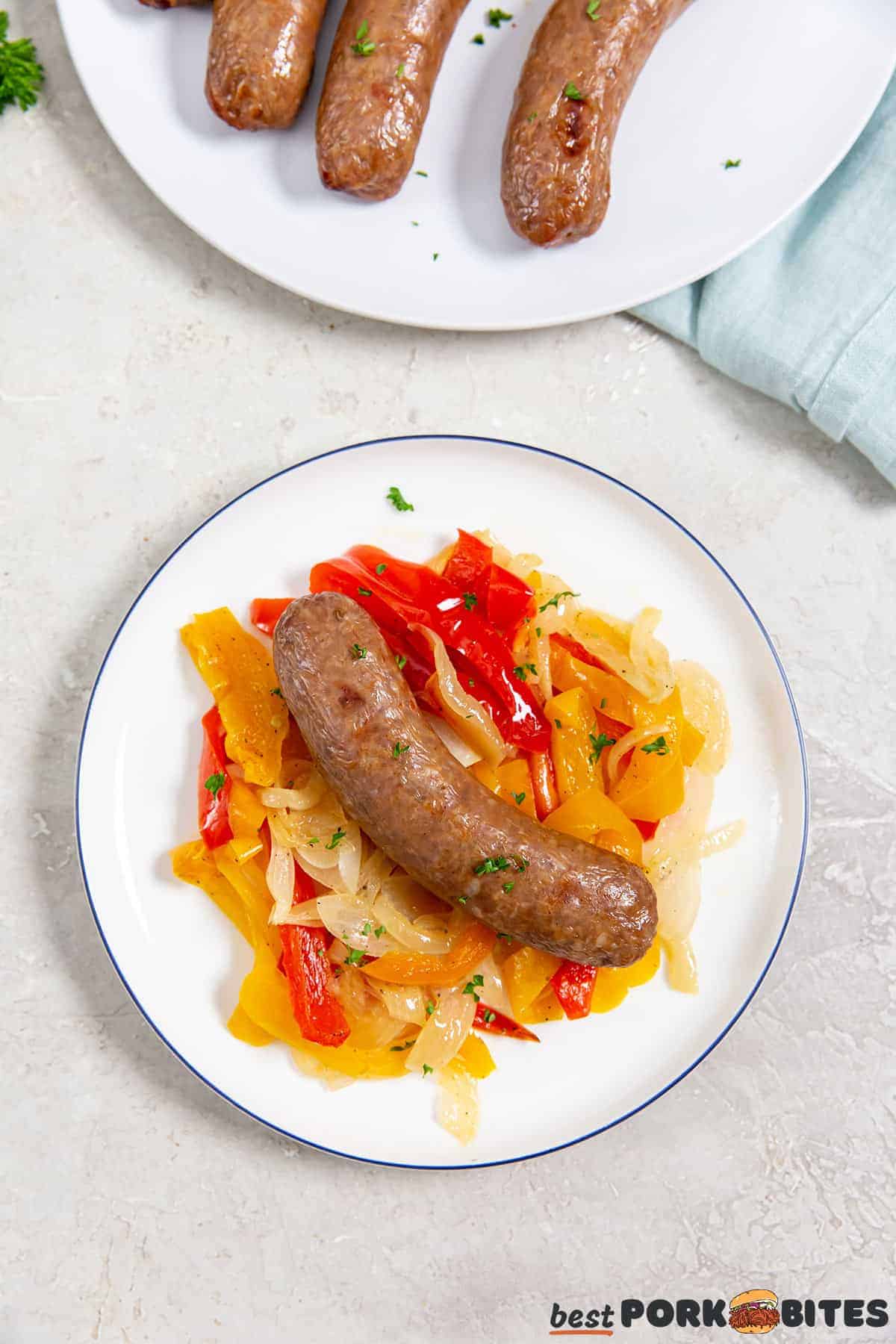 air fryer Italian sausage on a plate with sautéed peppers