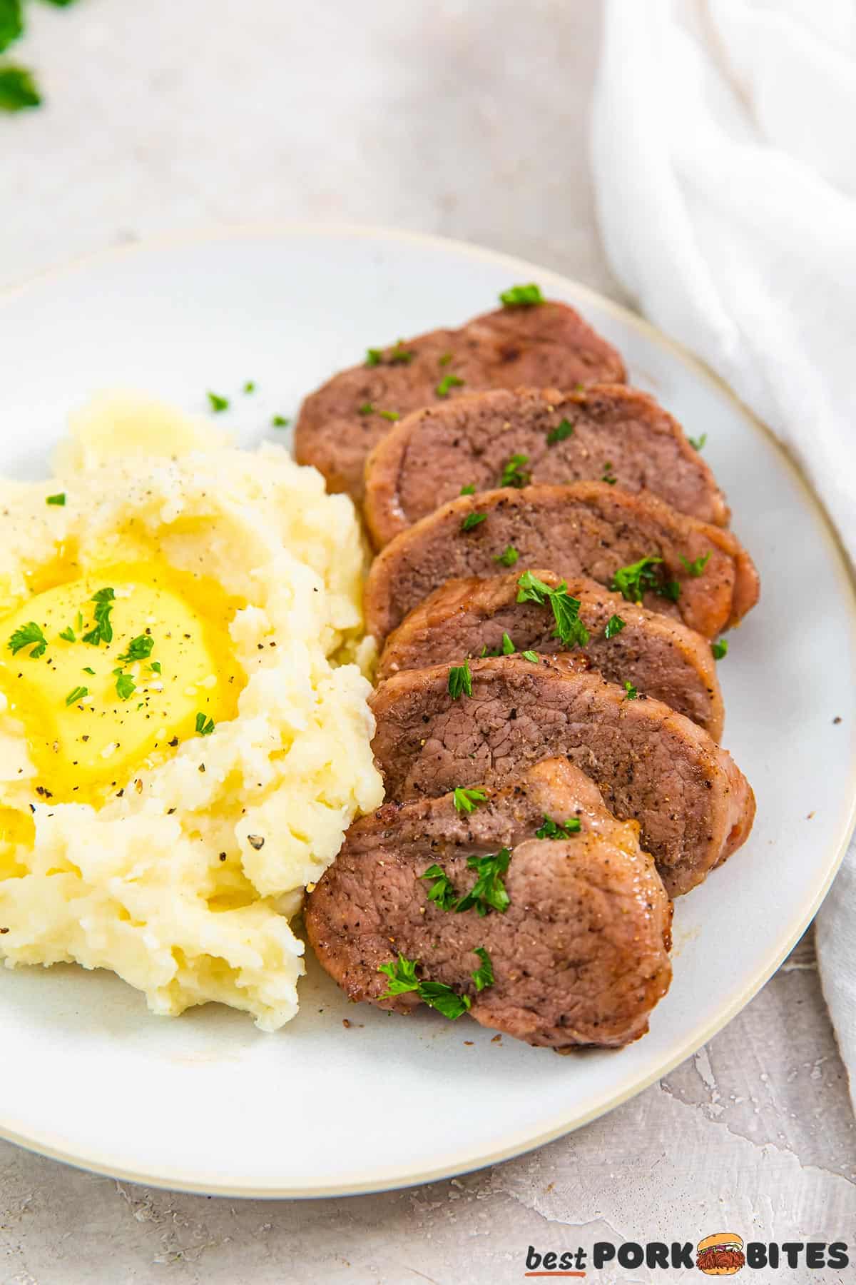 mashed potatoes and pork on a white plate