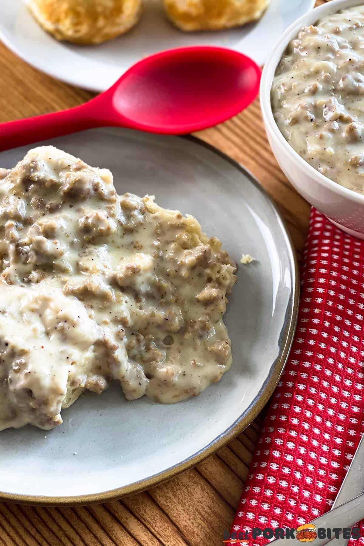 a plate of sausage gravy and biscuits