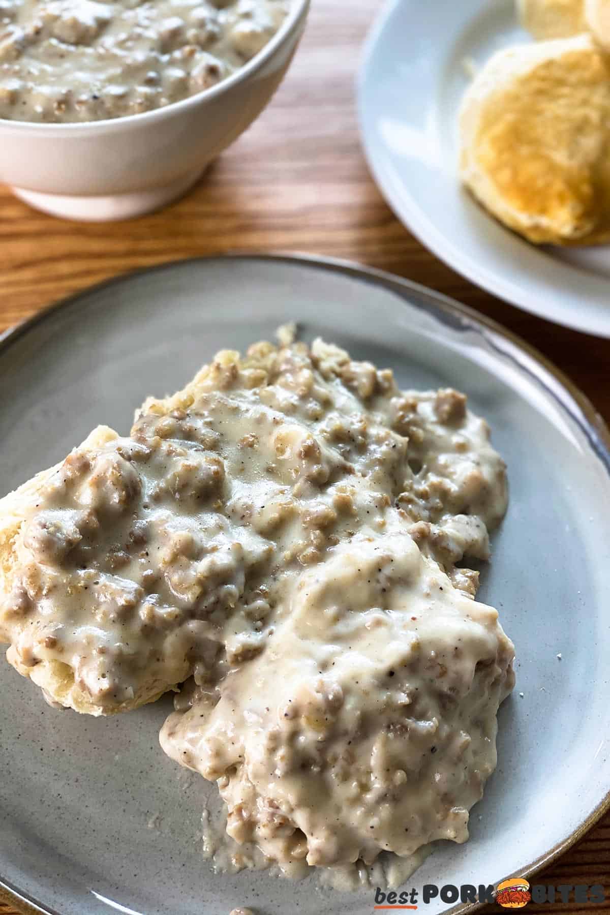 a plate of gravy biscuits with more gravy and biscuits in the background