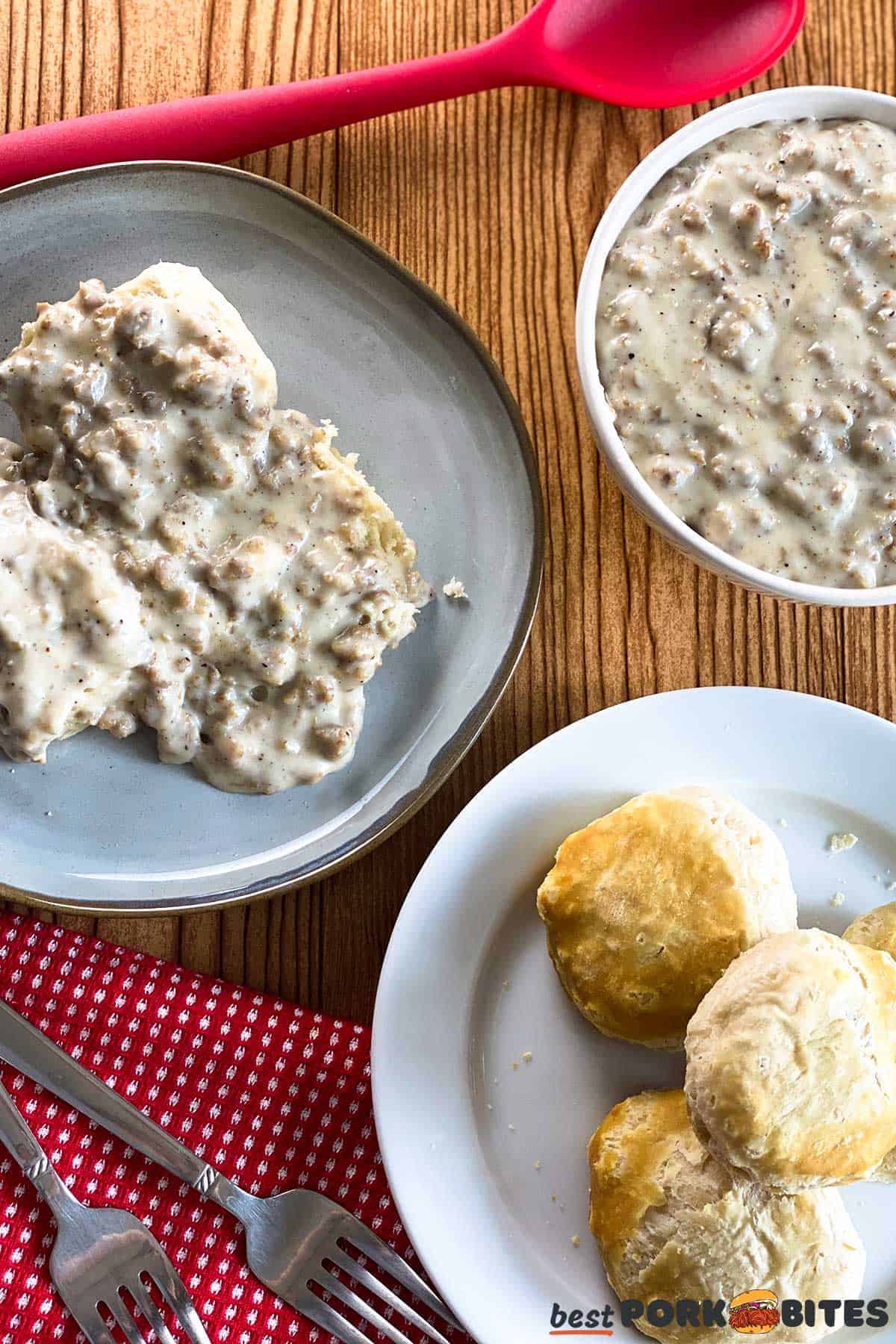 a plate of biscuits, a plate of biscuits and gravy, and a bowl of gravy on a table with a spoon and cutlery