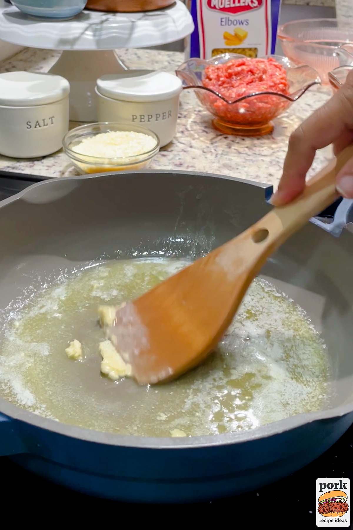 stirring garlic in a blue pan