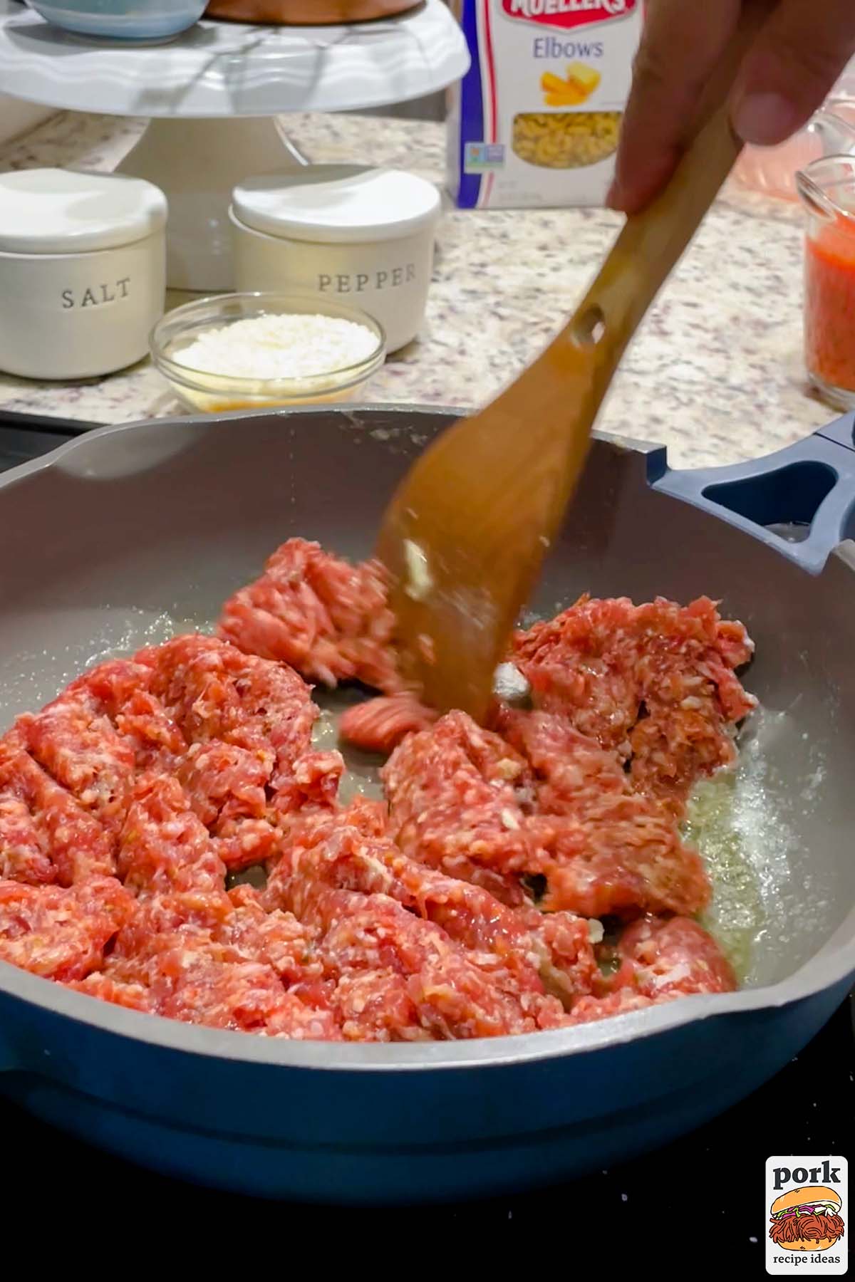 breaking apart sausage in a pan