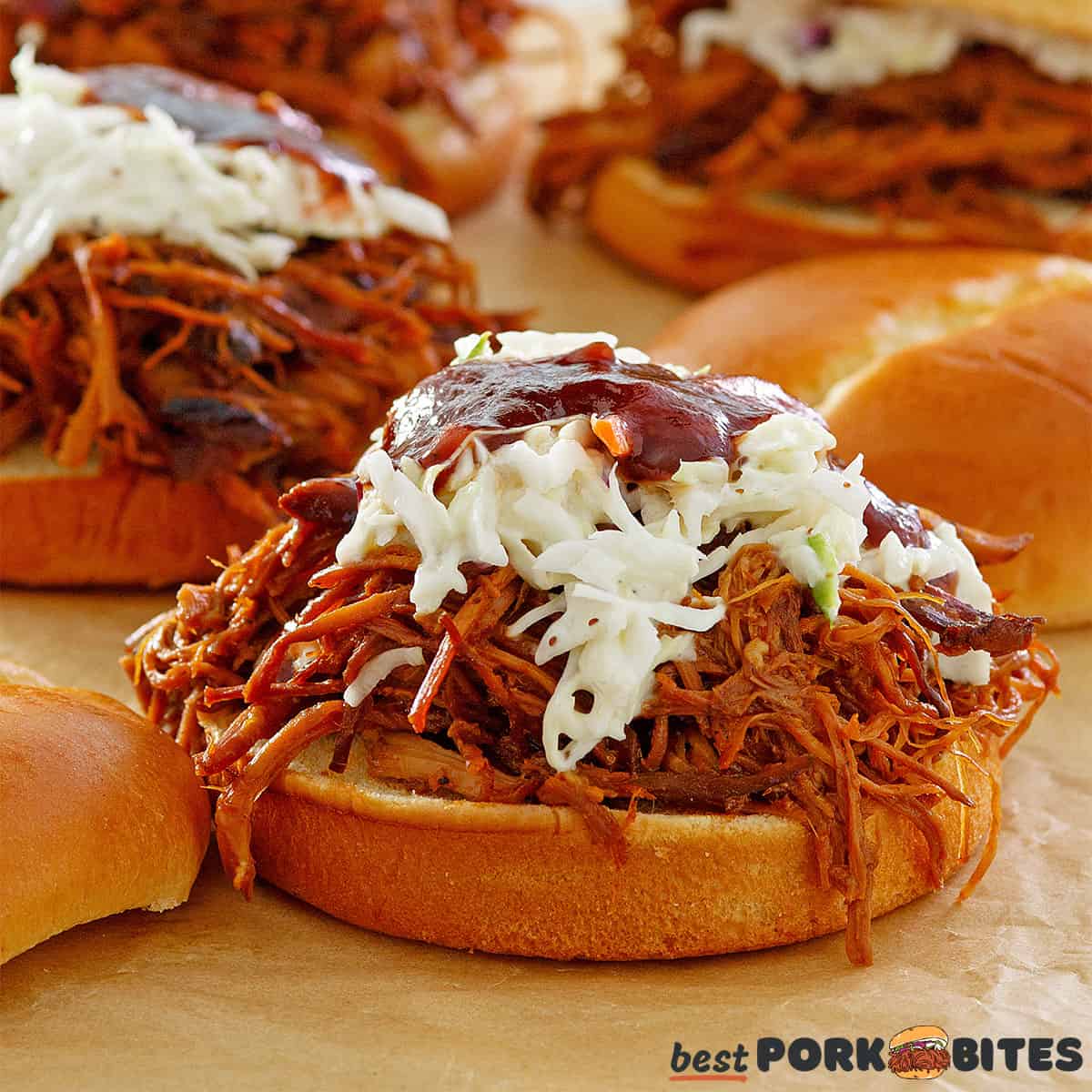 a close up of a crockpot bbq sandwich with bbq sauce and coleslaw