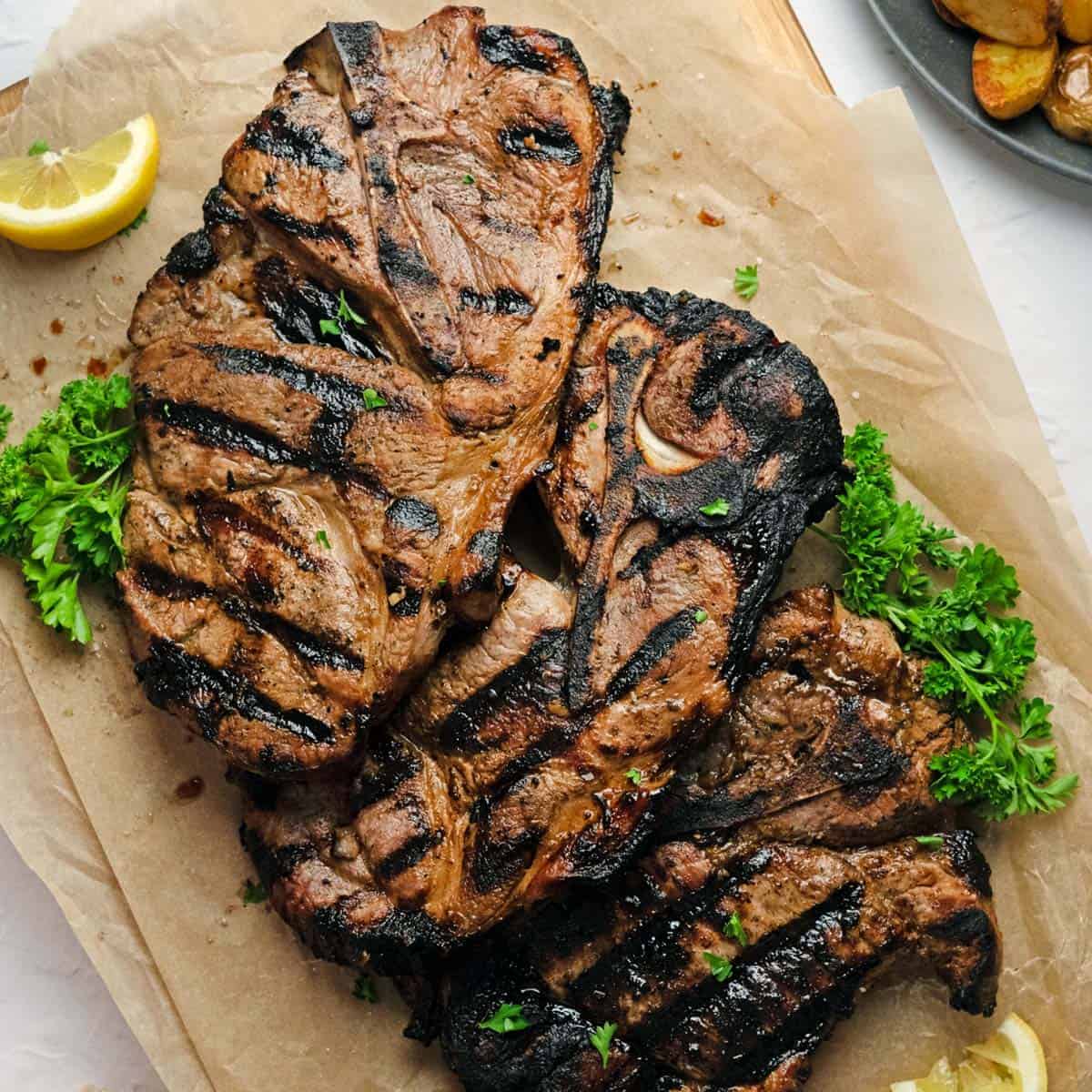grilled pork steaks on butcher paper