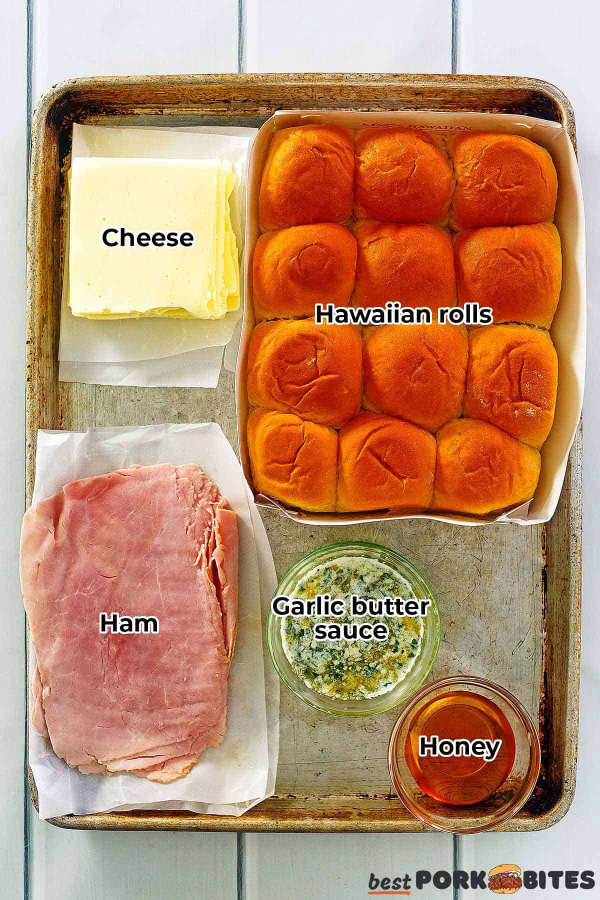 ingredients for ham and cheese sliders labeled on a tray