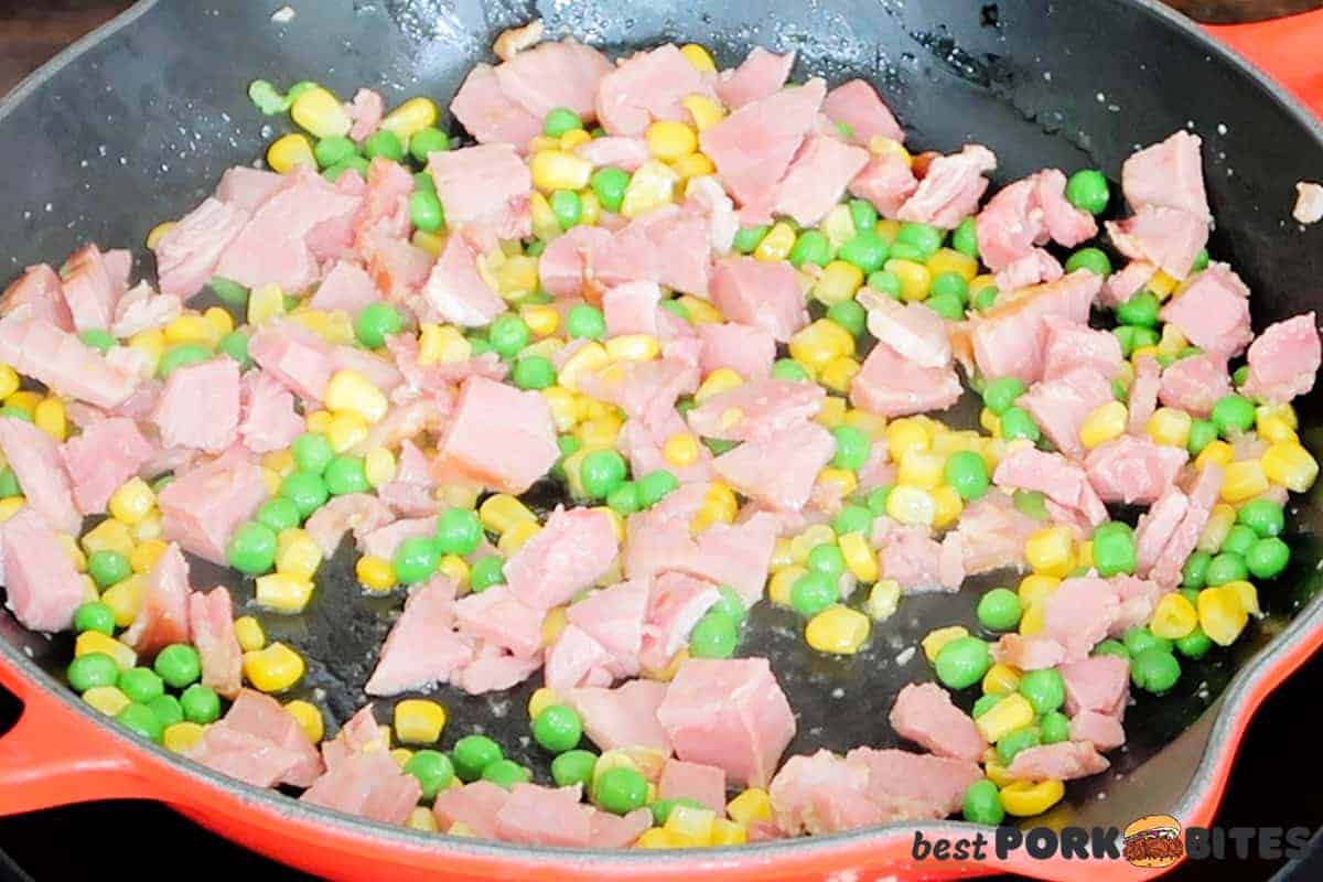 ham, frozen peas and corn in a skillet