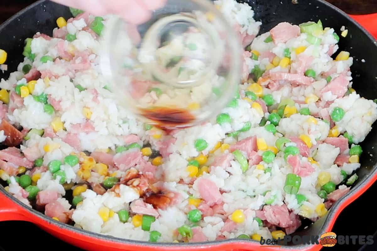 adding soy sauce to ham fried rice