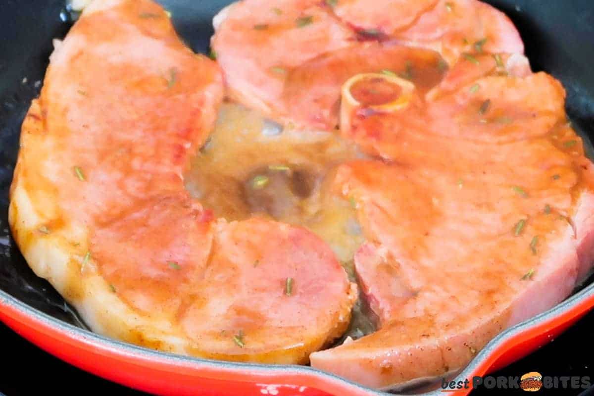 ham steaks in a pan with glaze