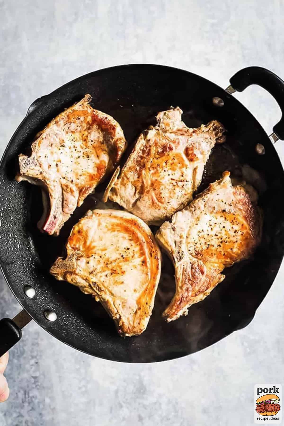 pan fried pork chops in a pan