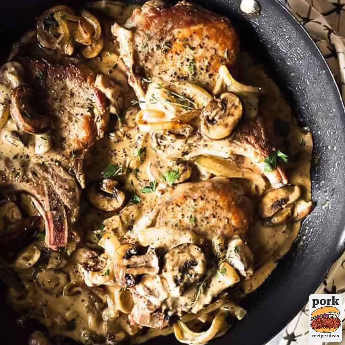 pork chops in mushroom gravy in a pan