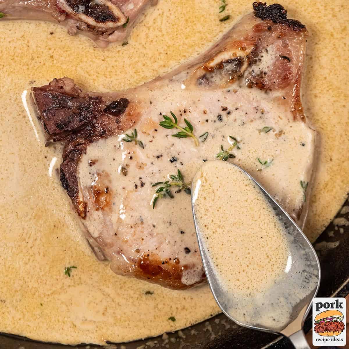 a spoon pouring mustard sauce on to a pork chop