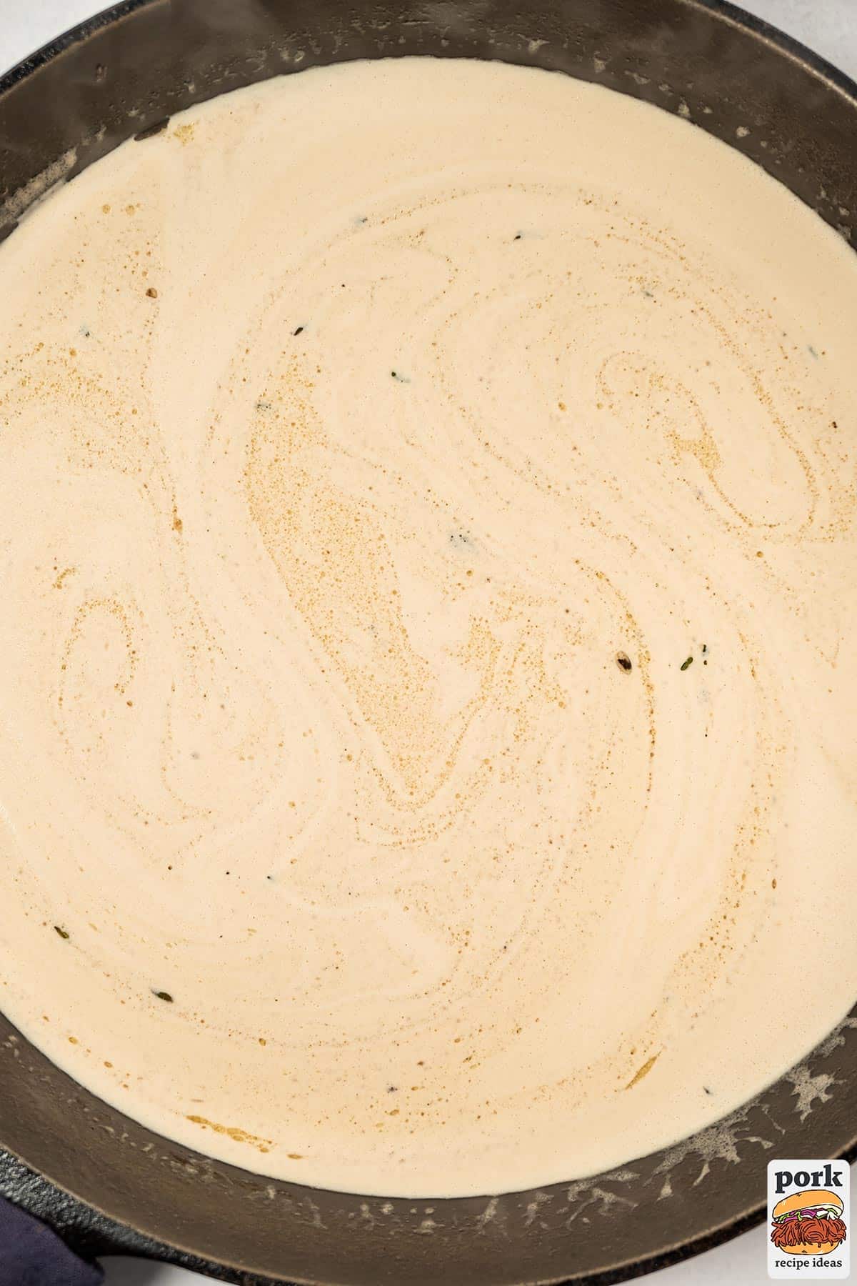 creamy whisked mustard sauce in a pan ready to serve
