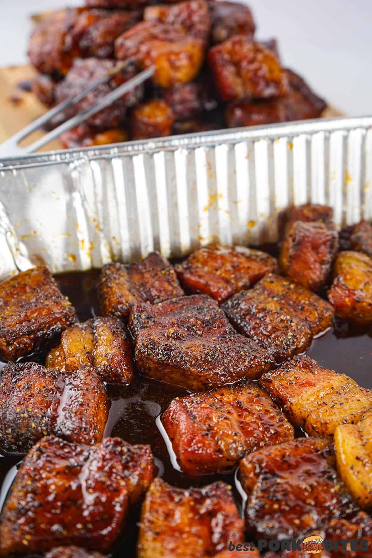 a metal baking dish of BBQ pork belly