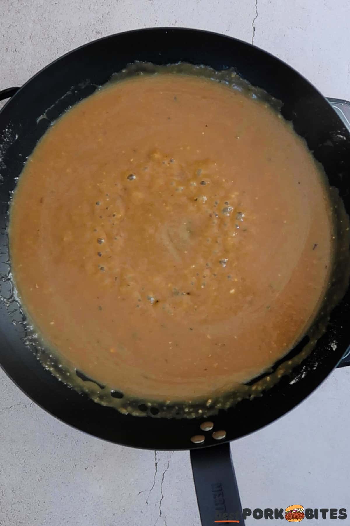 a pan with simmering gravy