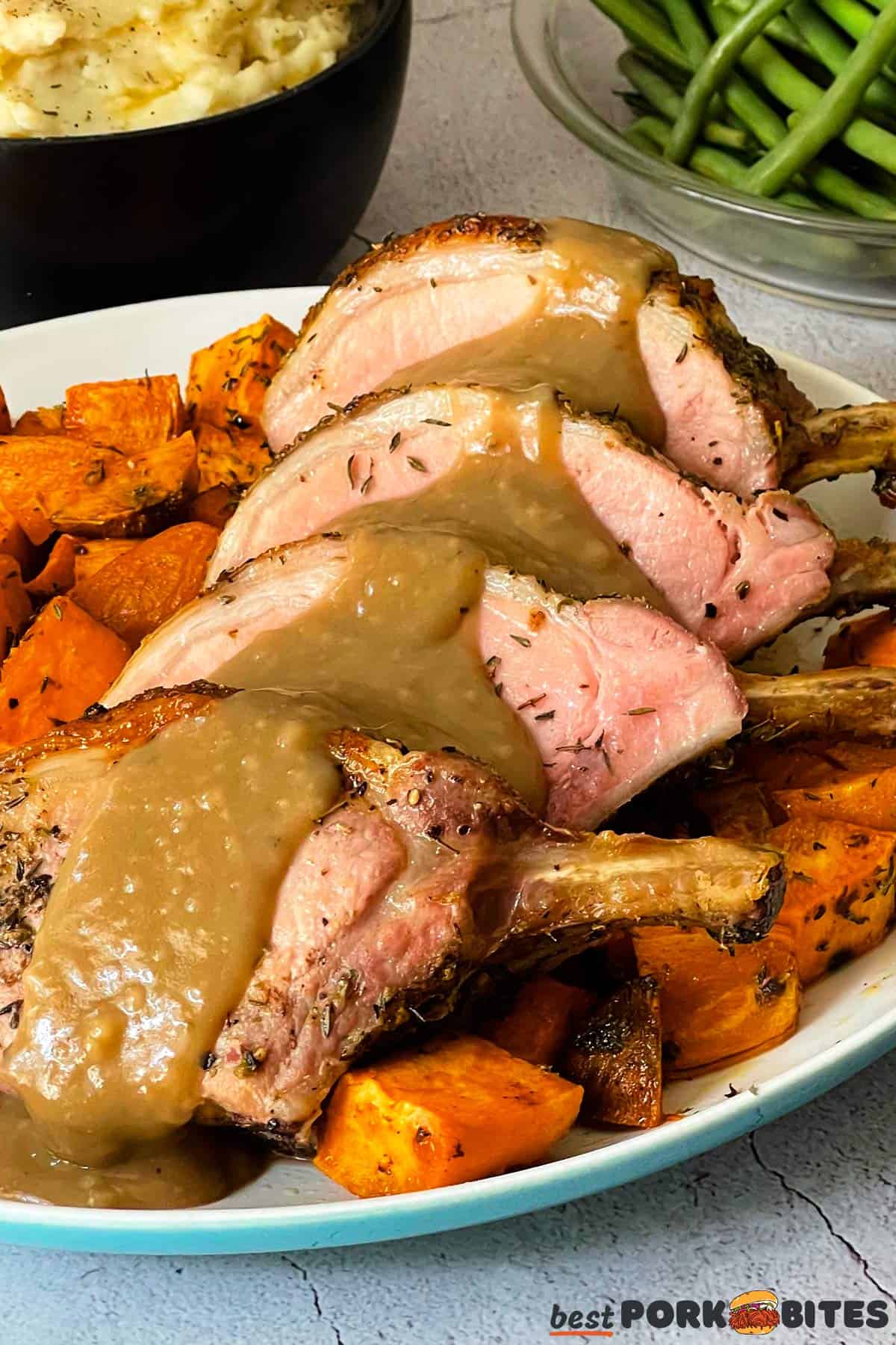 A plat ef pork chops, sweet potatoes and gravy