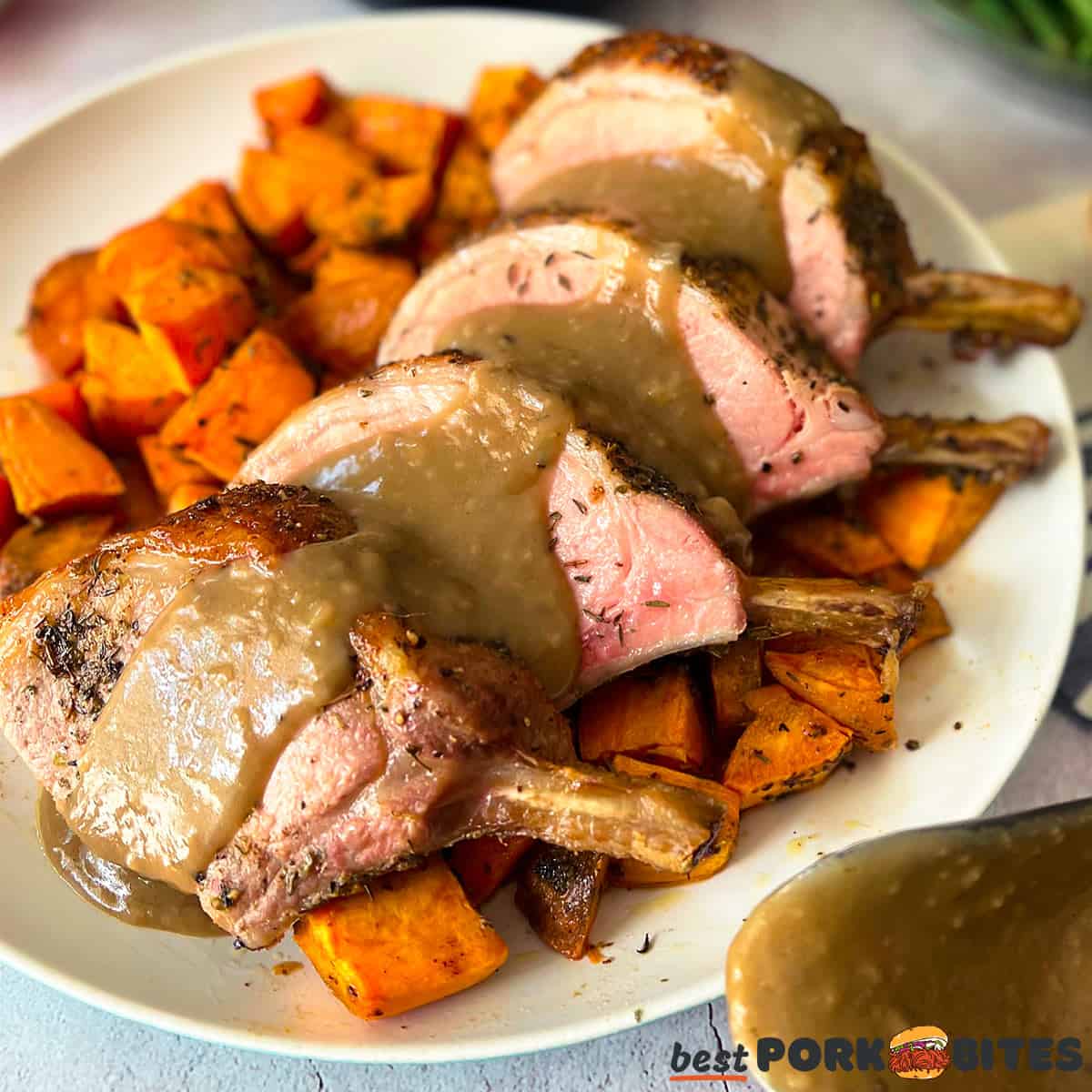 a plate of pork robs and sweet potatoes with gravy