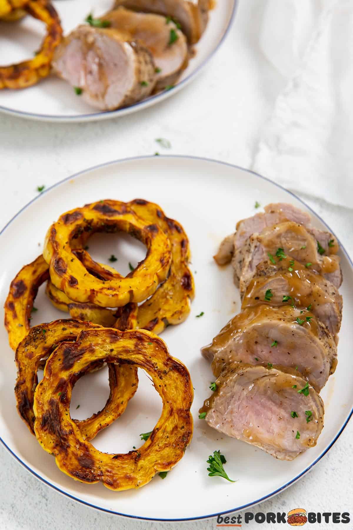 a dinner plate with instant pot pork tenderloin, gravy, and roast squash