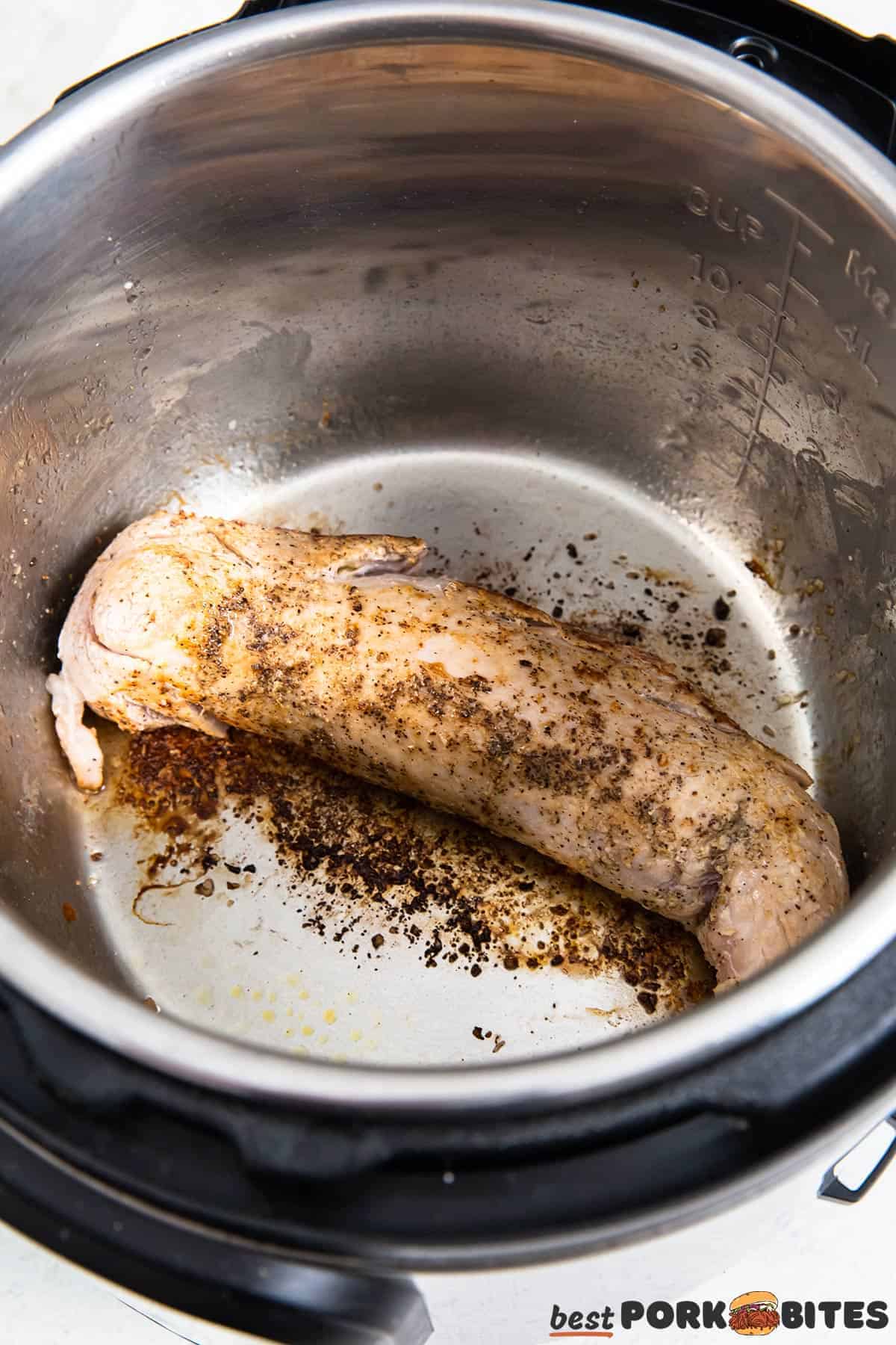 pork loin in an instant pot after being sauteed until browned