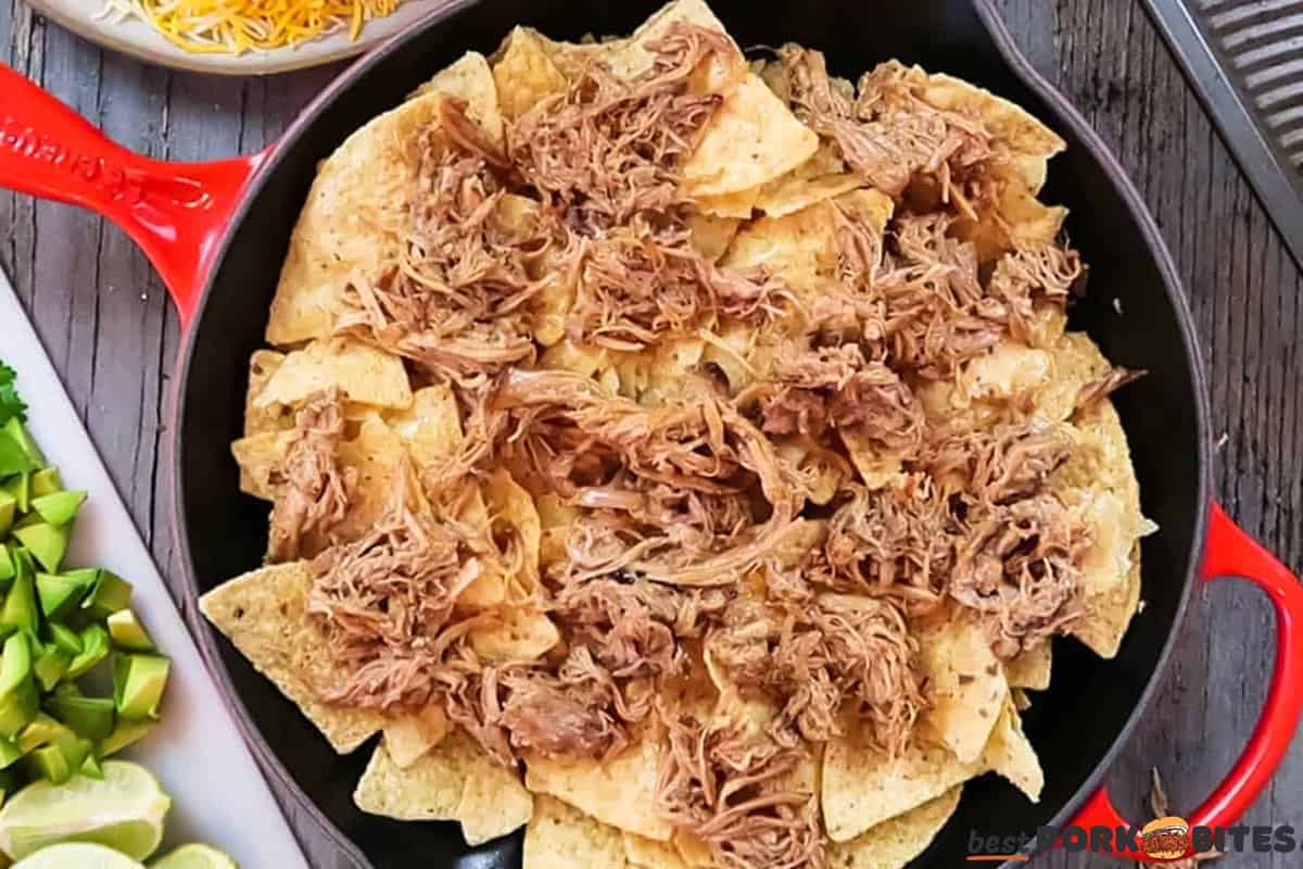 a skillet filled with chips topped with pulled pork