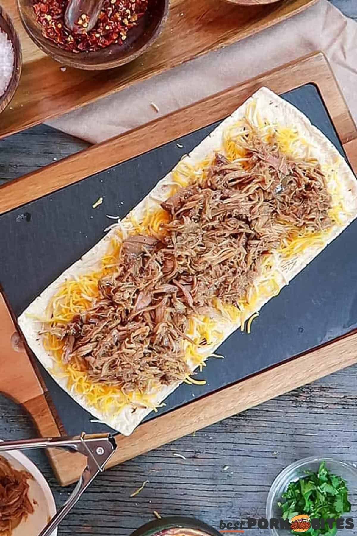 a flatbread with a layer of cheese and pulled pork