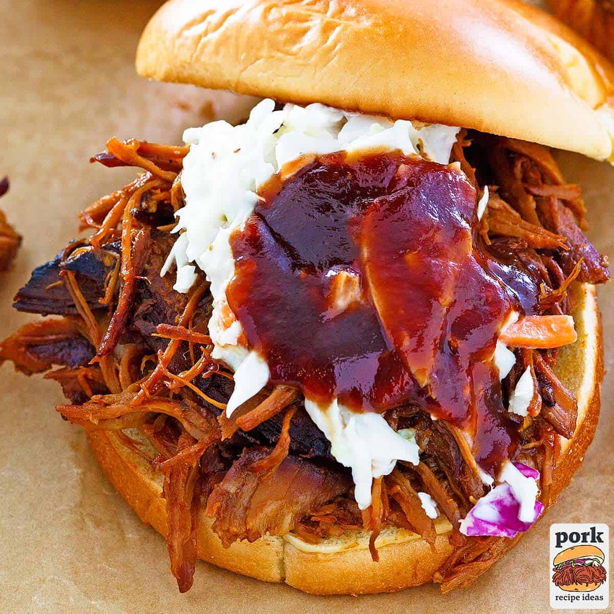 a pulled pork sandwich with coleslaw and barbecue sauce