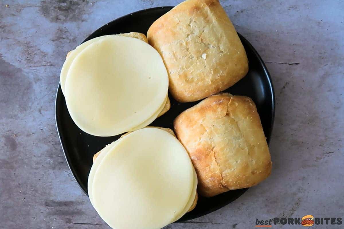 sliced cheese added to sandwich rolls