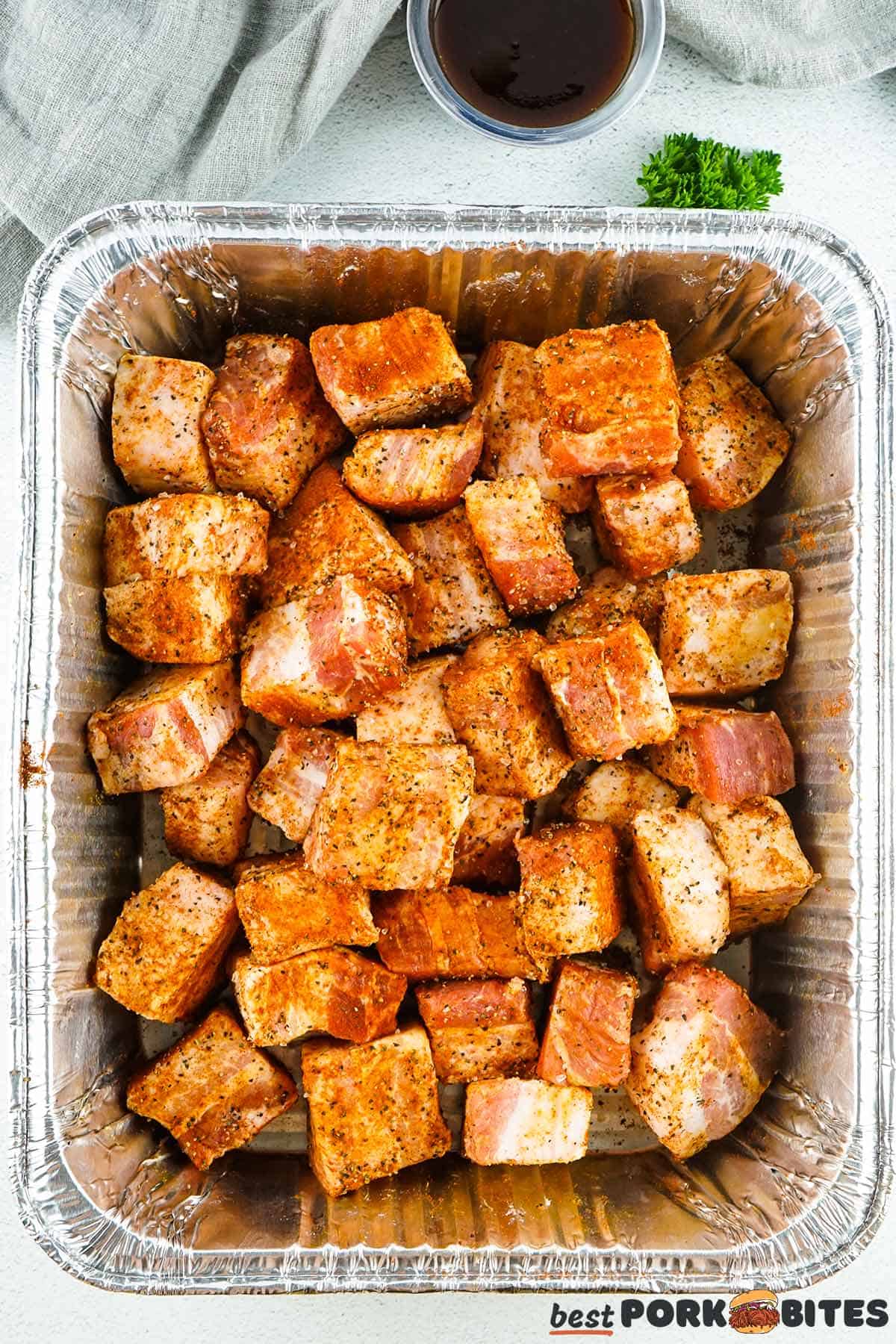 seasoned pork belly slices in a metal pan