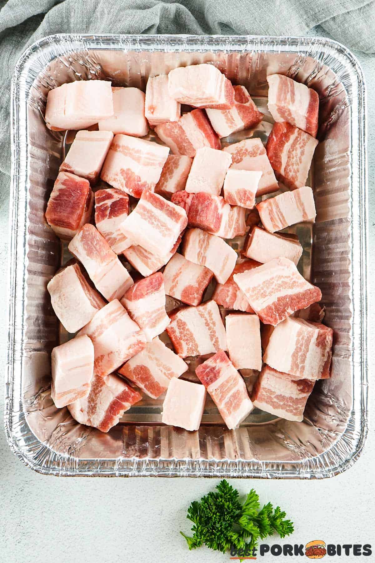 raw pork belly slices in a metal pan