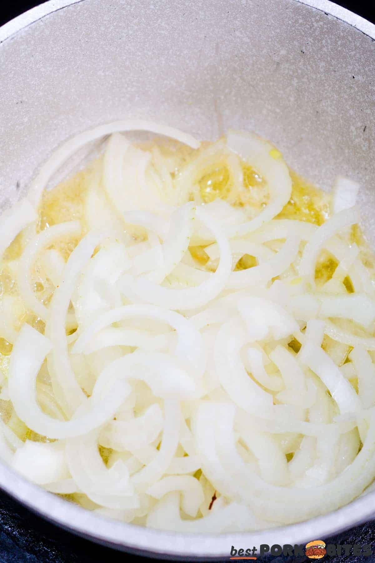onions being sauteed in melted butter