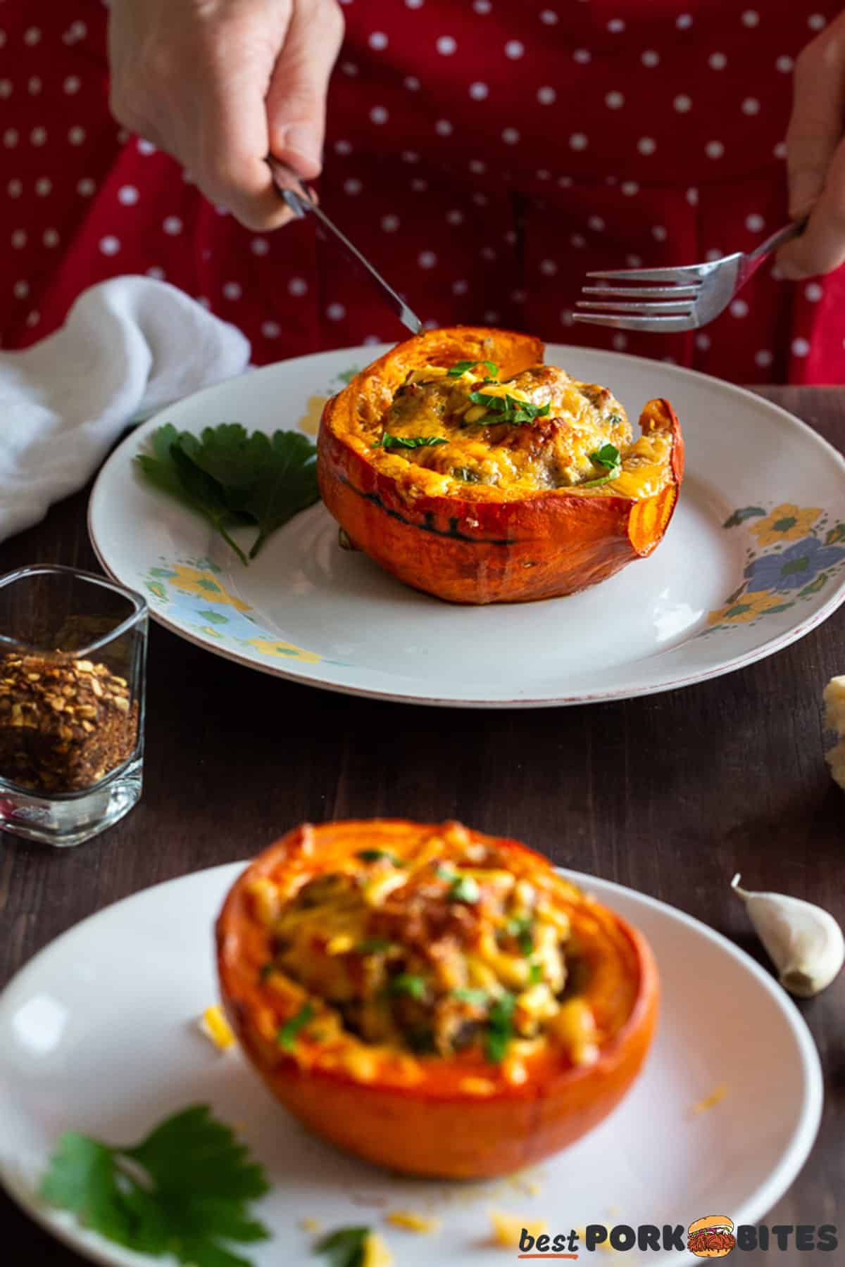 two plates with stuffed squash with hands cutting into one squash